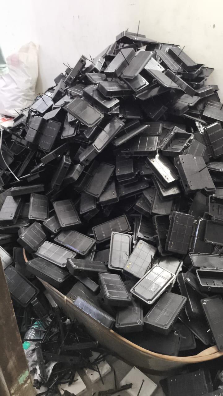 A bin overflowing with freshly injection-moulded plastic enclosures